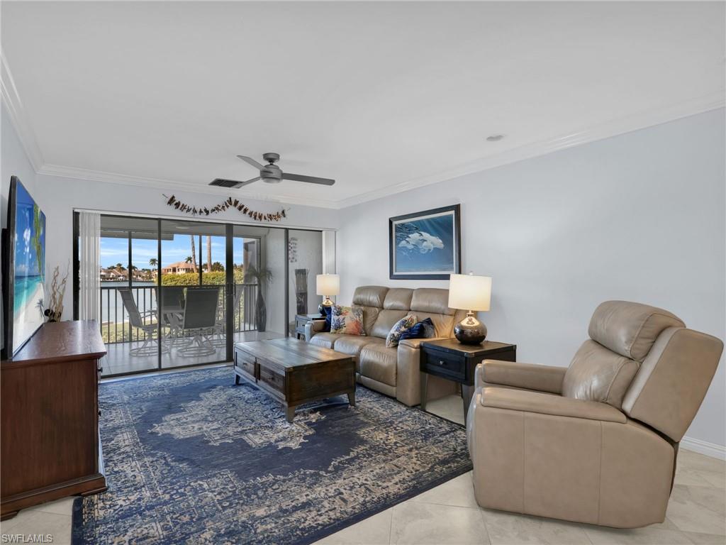 750 West Elkcam Circle, Unit 107 Marco Island, FL 34145 - Photo 7 of 33 Living area featuring ornamental molding, ceiling fan, and light tile patterned floors