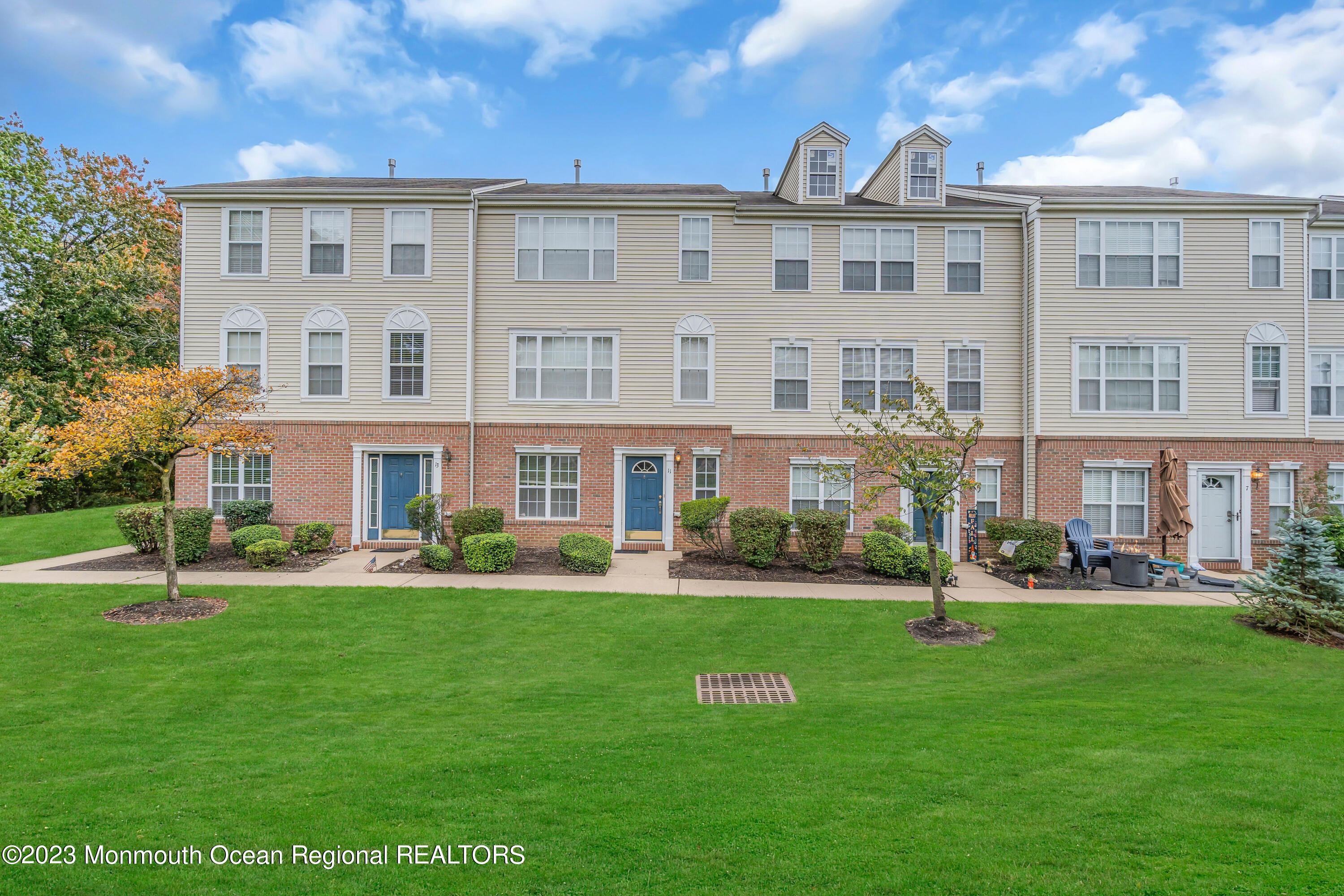 a front view of a building with a garden