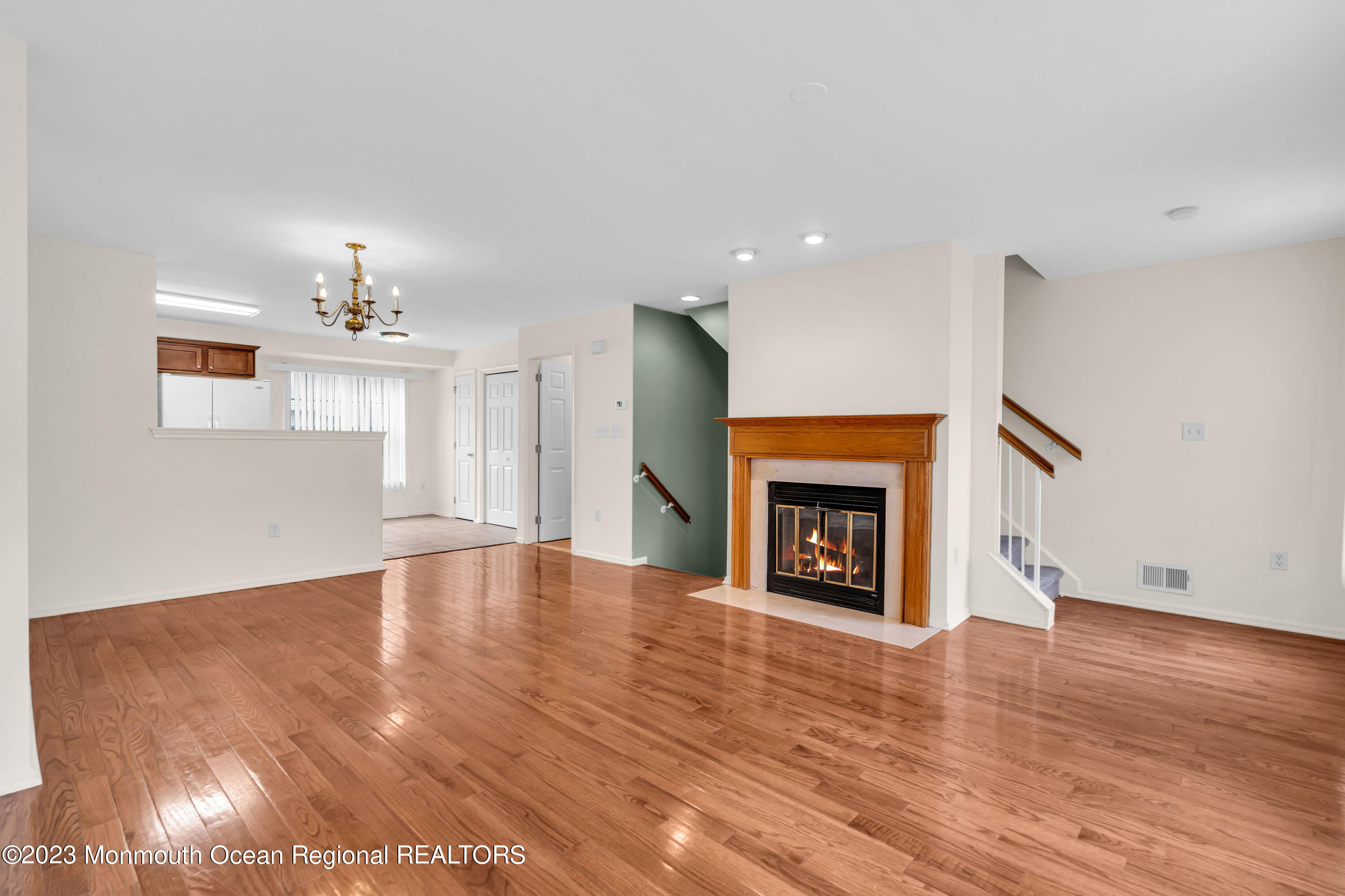 11 Kosmoski Terrace, Unit 106 Parlin, NJ 08859 - Photo 6 of 19 a view of an empty room with wooden floor fireplace and a window