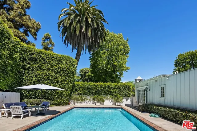 a view of a backyard with potted plants