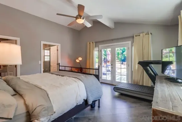 a bedroom with a bed a large bed and a large window