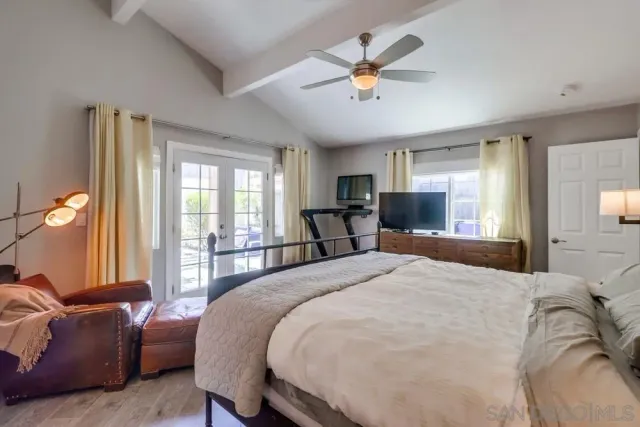 a bedroom with a large bed and a chandelier