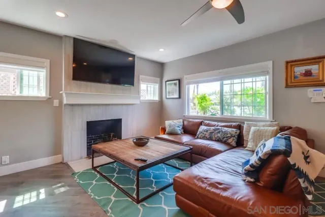 a living room with furniture fireplace and flat screen tv