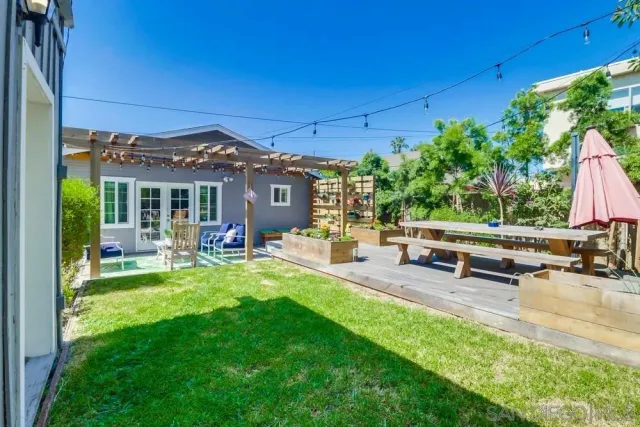 a view of a house with backyard porch and sitting area