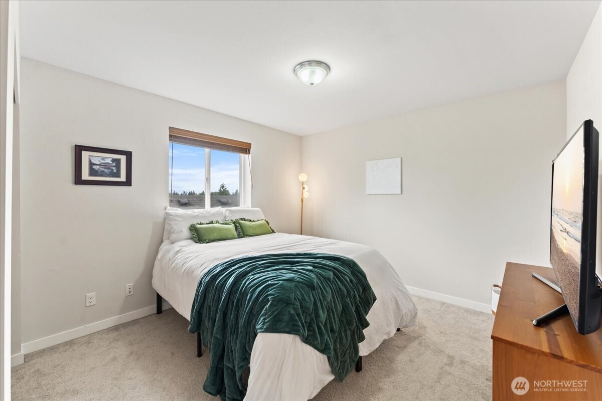 12418 2nd Place Southwest Burien, WA 98146 - Photo 18 of 39 a bedroom with a bed and a flat screen tv