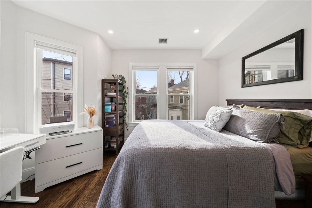 12-14 Porter Street, Unit 12 Boston, MA 02130 - Photo 15 of 37 a bedroom with a large bed and a window