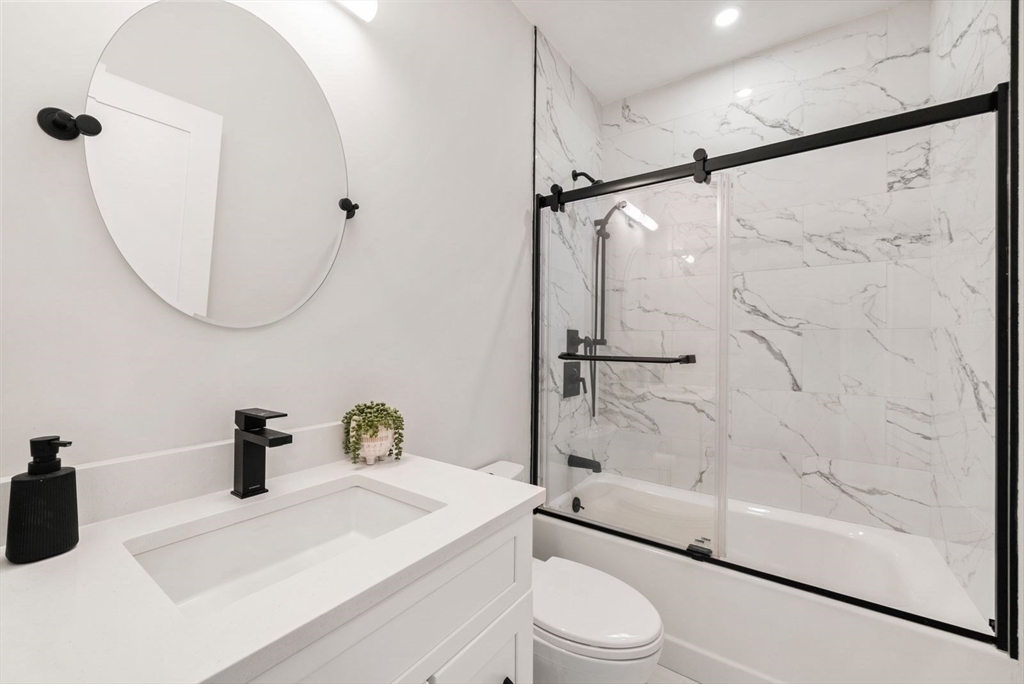 12-14 Porter Street, Unit 12 Boston, MA 02130 - Photo 19 of 37 a bathroom with a sink a toilet and a shower