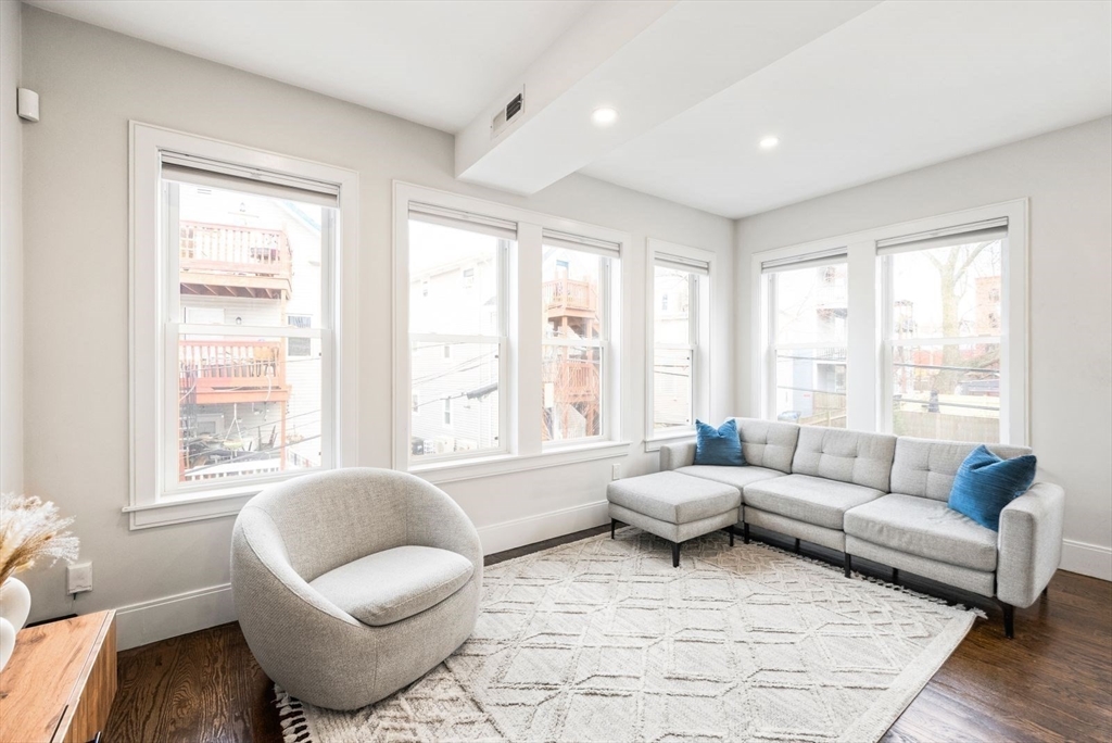 12-14 Porter Street, Unit 12 Boston, MA 02130 - Photo 2 of 37 a living room with furniture and a large window