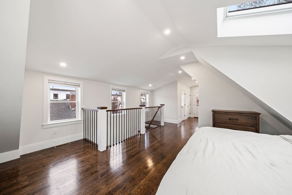 12-14 Porter Street, Unit 12 Boston, MA 02130 - Photo 26 of 37 a view of a livingroom with wooden floor and windows