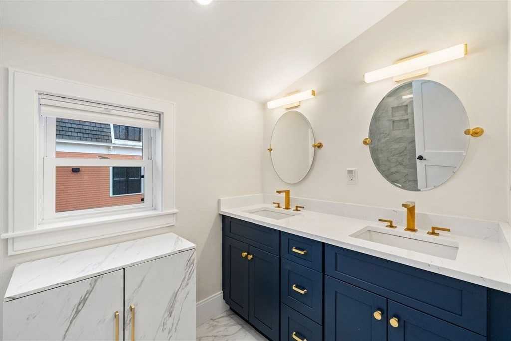 12-14 Porter Street, Unit 12 Boston, MA 02130 - Photo 29 of 37 a bathroom with a double vanity sink mirror and