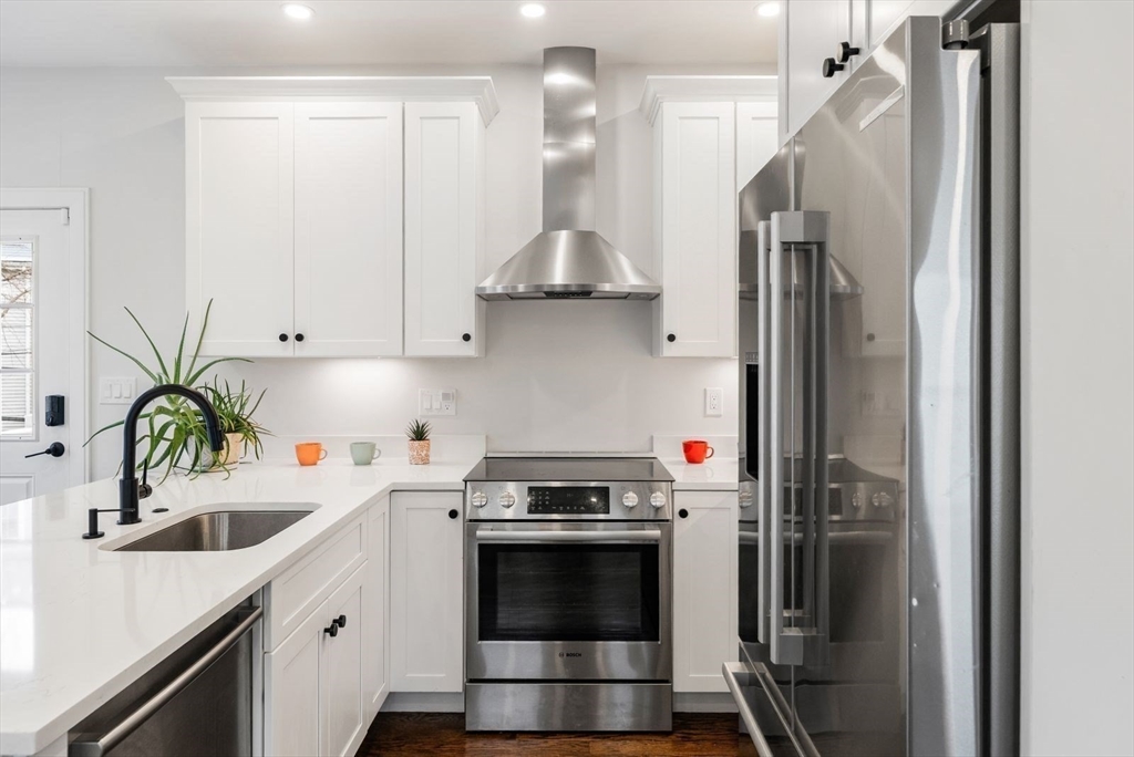 12-14 Porter Street, Unit 12 Boston, MA 02130 - Photo 7 of 37 a kitchen with stainless steel appliances a stove a refrigerator and a sink