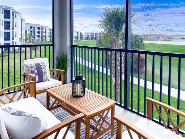 a view of a balcony with two chairs and a table