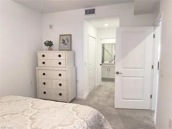 a view of a bedroom with cabinet and cabinet