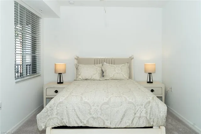 a large white bed in a white room