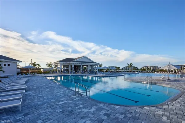 a view of swimming pool with outdoor seating and city view