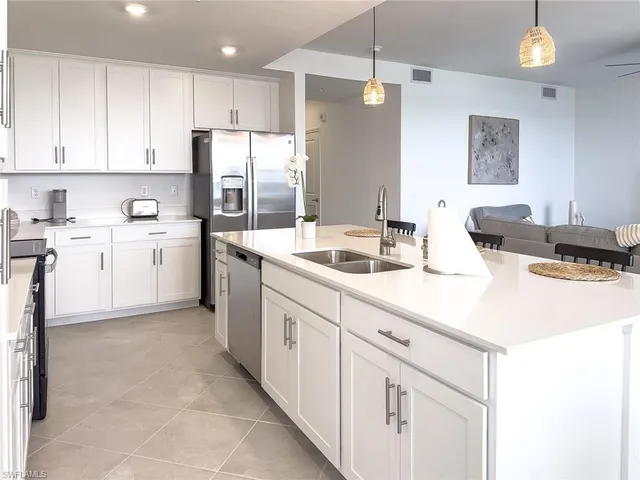 a kitchen with white cabinets sink and white appliances