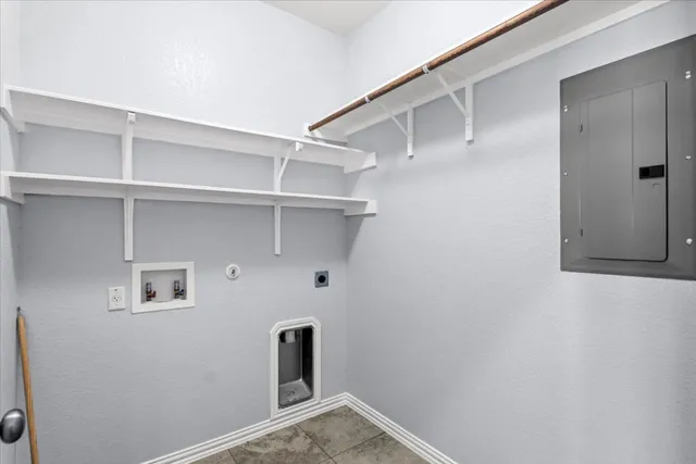 a view of storage and utility room with closet