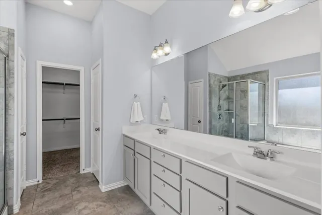 a bathroom with a double vanity sink and a mirror