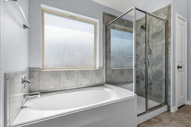 a bathroom with a tub and a shower