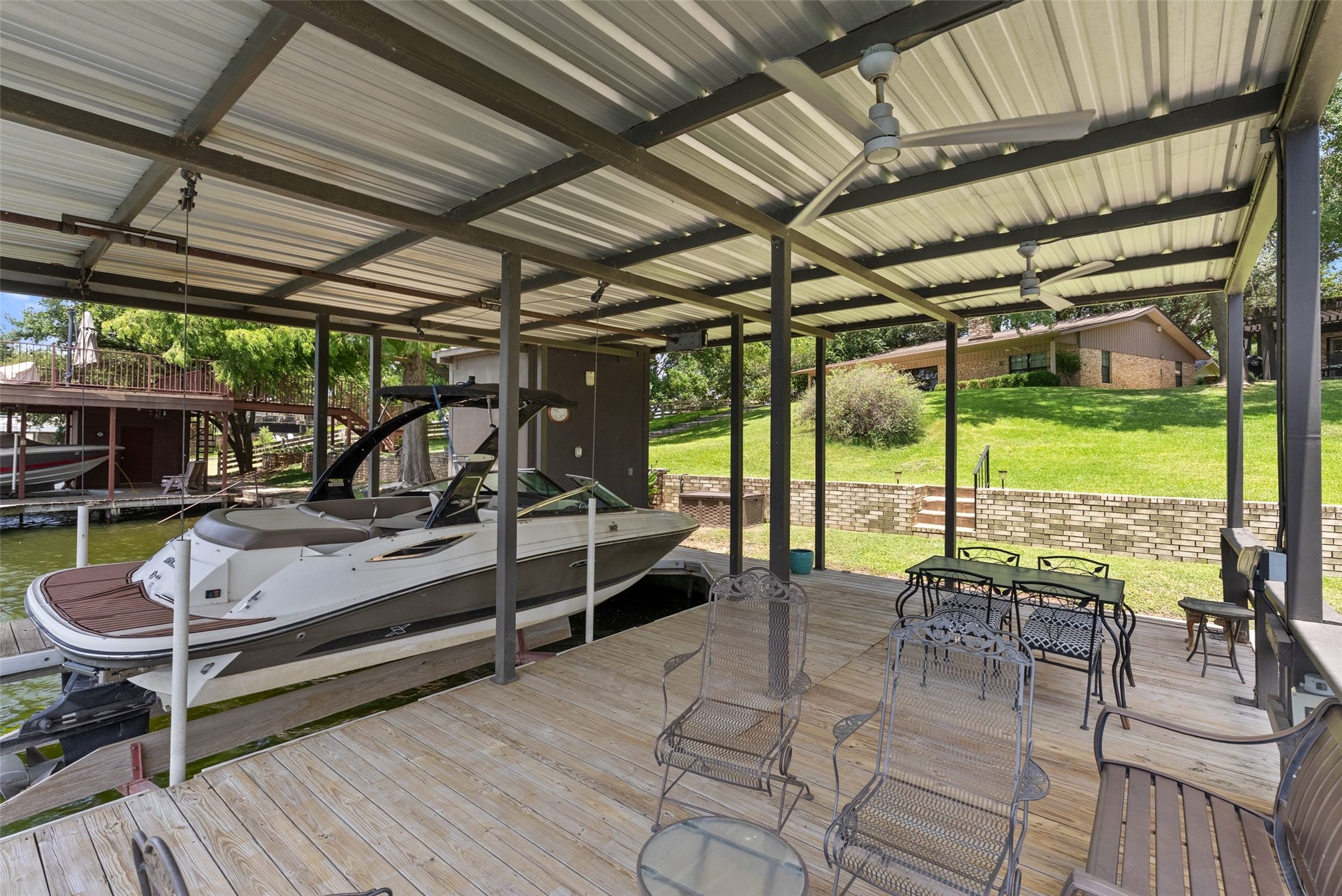 141 Perry Lane Kingsland, TX 78639 - Photo 13 of 40 Boathouse with covered dock and ample outdoor living space perfect for waterside entertaining.