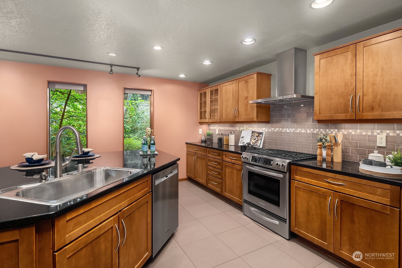16117 Southeast 145th Place Renton, WA 98059 - Photo 12 of 38 a kitchen with stainless steel appliances granite countertop a sink stove and cabinets