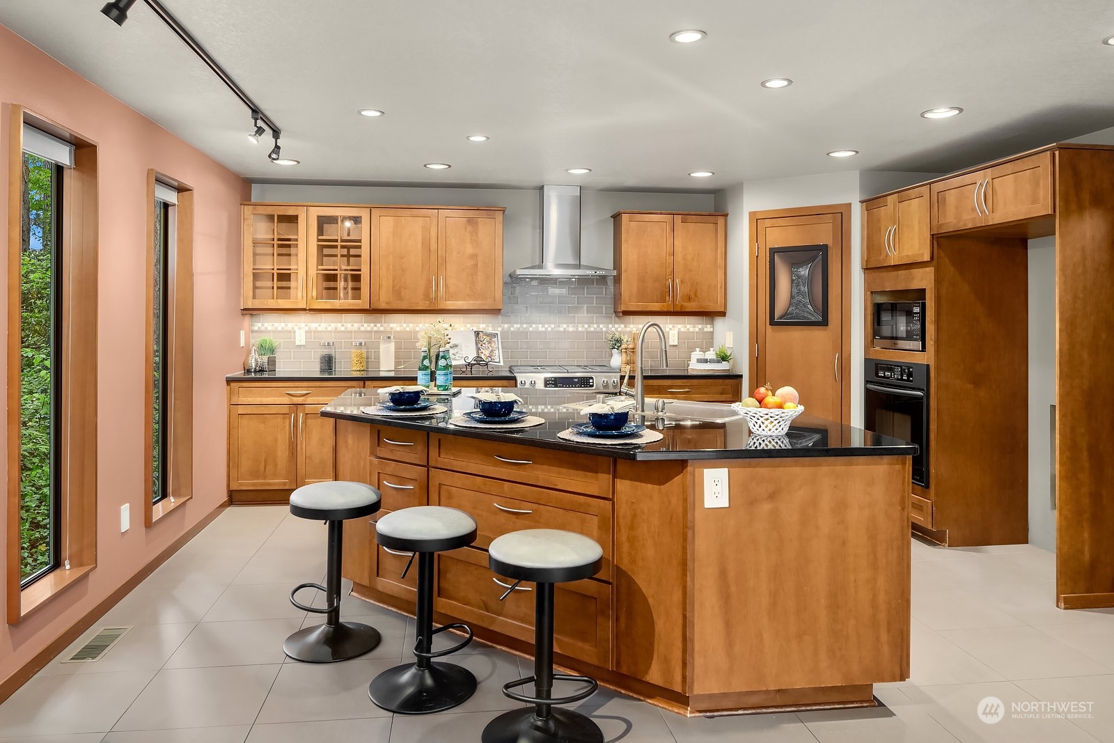 16117 Southeast 145th Place Renton, WA 98059 - Photo 10 of 38 a kitchen with stainless steel appliances granite countertop a refrigerator a stove and a sink with wooden floor