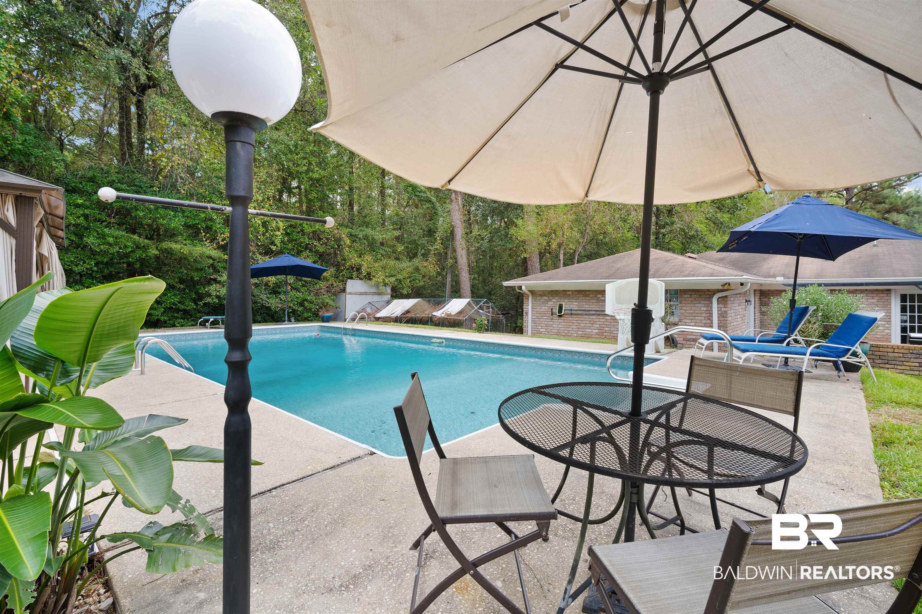 7807 Yorkhaven Road Mobile, AL 36695 - Photo 30 of 34 Swimming pool featuring a patio, view of scattered trees, and an outdoor structure