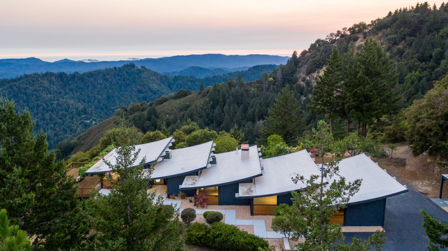 an aerial view of a house with mountain view