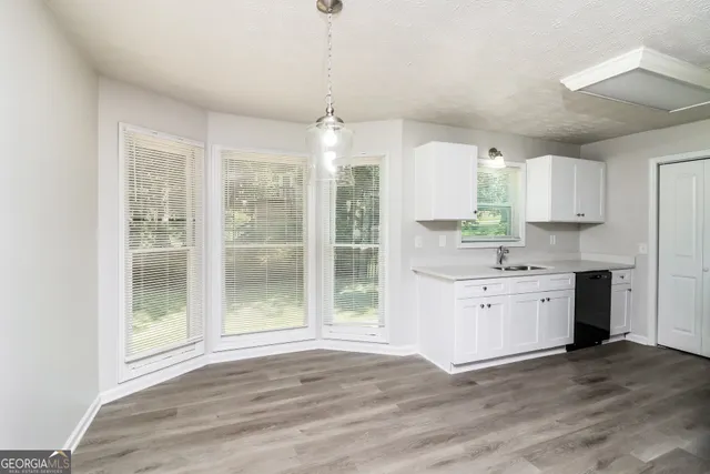 a kitchen with granite countertop a stove a sink and a refrigerator