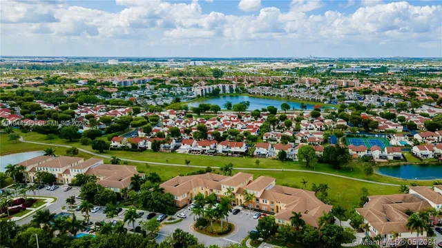 an aerial view of a city with lots of green space