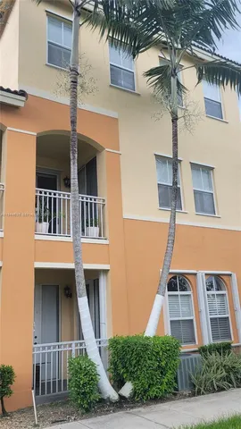a front view of a building with a garden