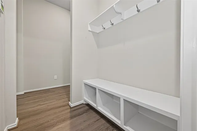 a view of an empty room with a window and closet