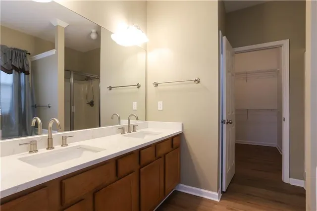 a bathroom with a double vanity sink and mirror