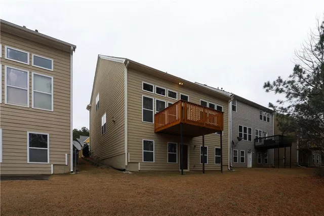 a view of a house with a parking space and balcony
