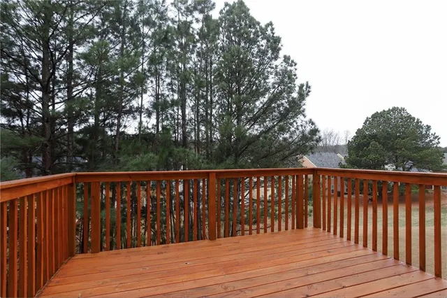 a balcony with wooden floor and fence