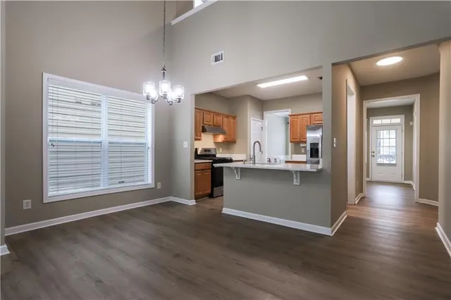 a view of a kitchen and dining room with wooden floor