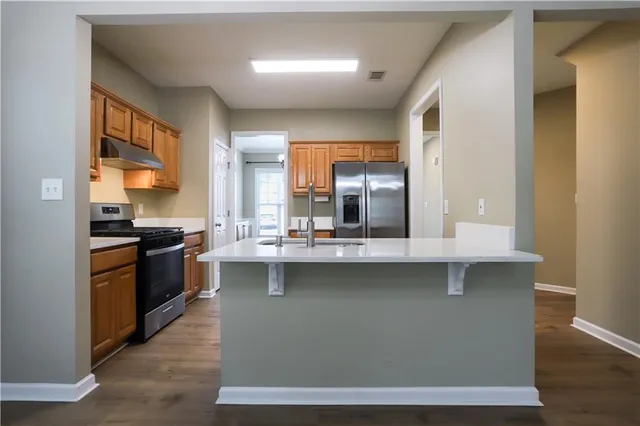 a kitchen with a sink stove and cabinets