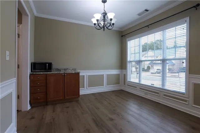 a view of wooden floor and windows in a room