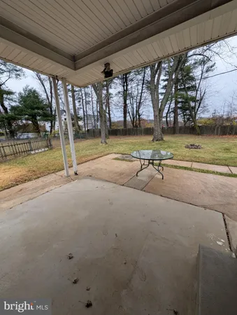 a view of a backyard with wooden fence