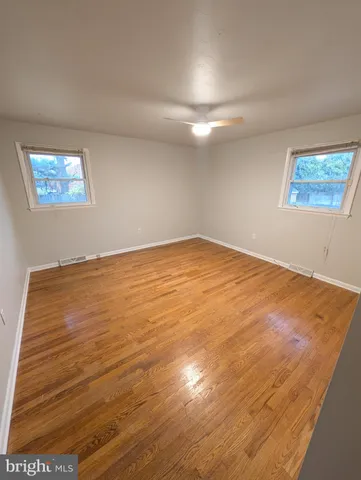 an empty room with wooden floor