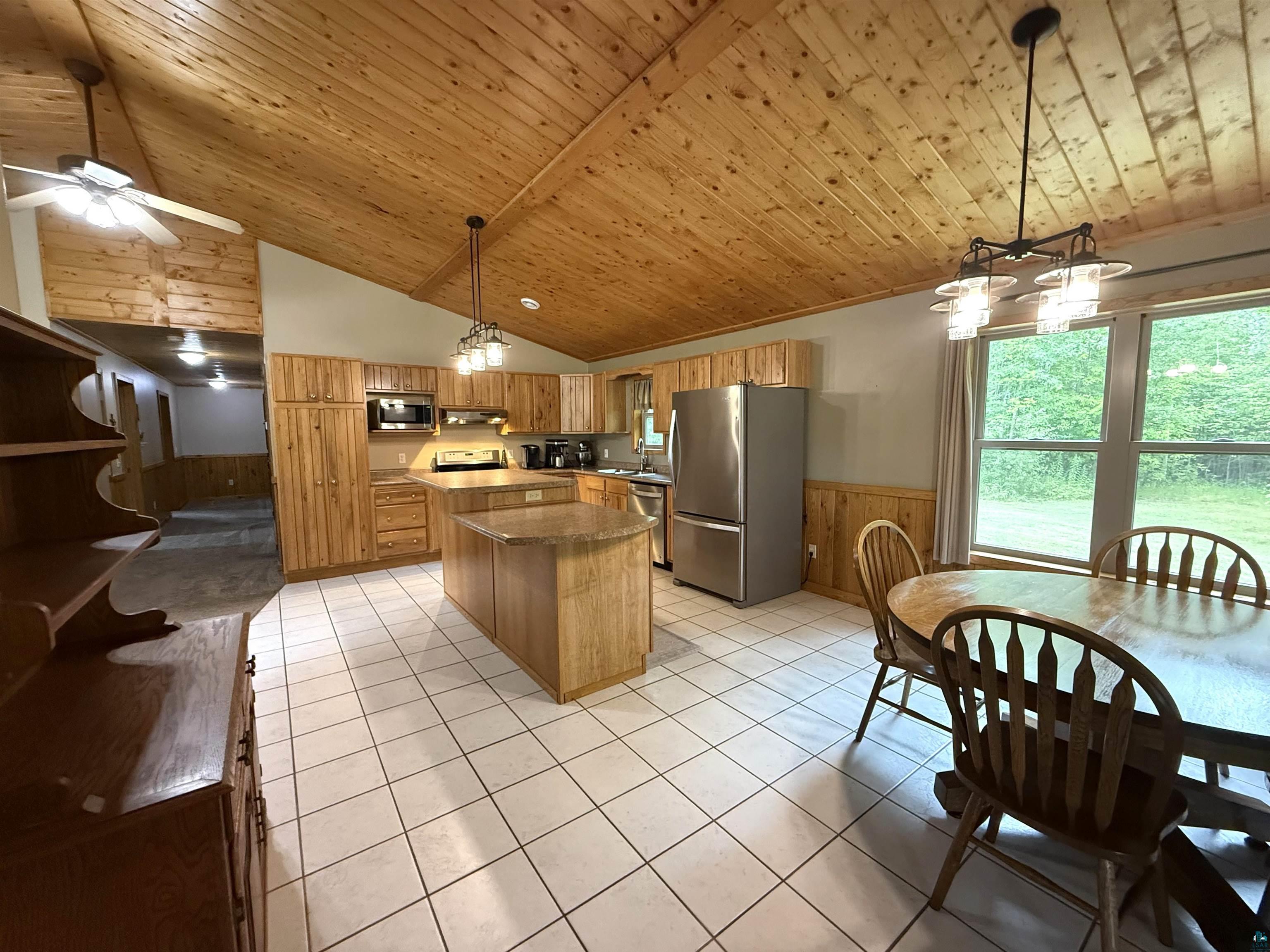 5080 Tower Road Moose Lake, MN 55767 - Photo 15 of 49 Kitchen featuring a vaulted wood-paneled ceiling, recessed lighting, tile flooring, and stainless steel appliances