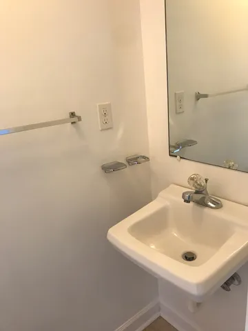 a view of an empty room with window and cabinet