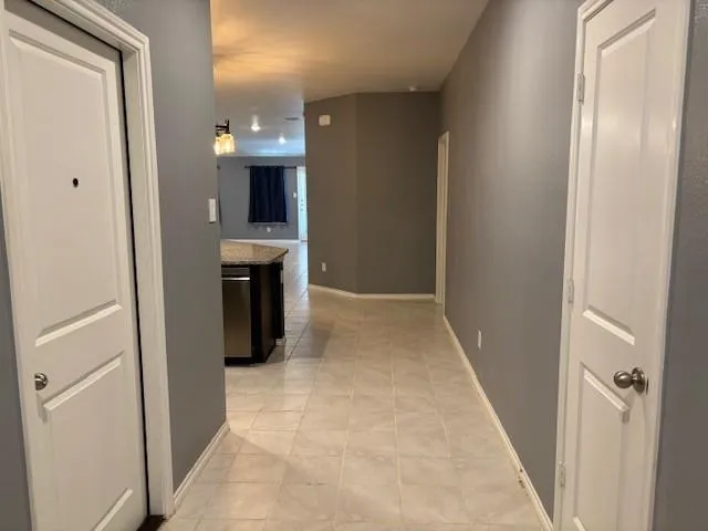 a view of a hallway and an empty room