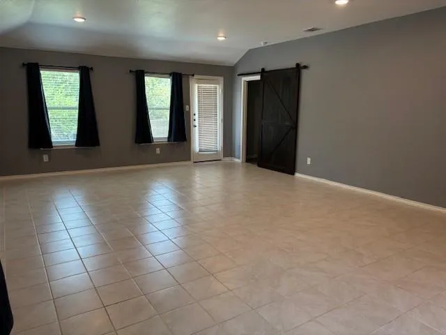 an empty room with windows and entrance