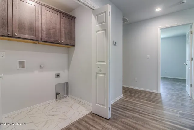 a view of a room with wooden floor and cabinets