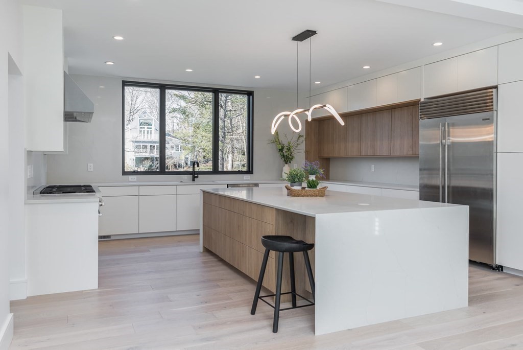 11 Willard Road Weston, MA 02493 - Photo 12 of 42 a large kitchen with a large window a sink a counter space and stainless steel appliances