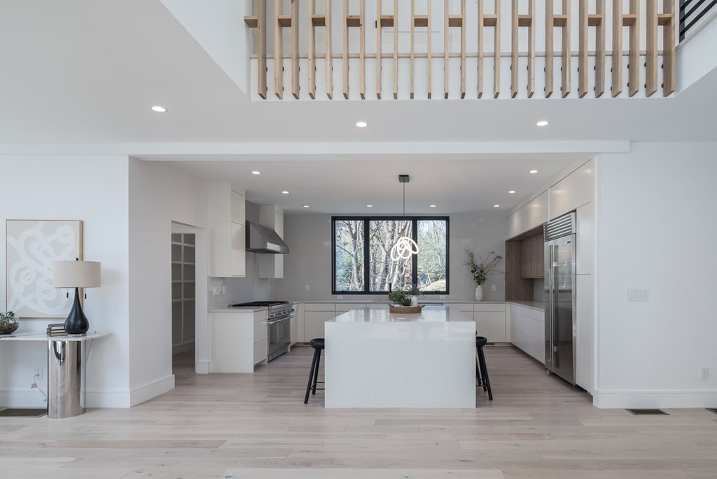 11 Willard Road Weston, MA 02493 - Photo 18 of 42 a living room with stainless steel appliances kitchen island granite countertop furniture and a fireplace