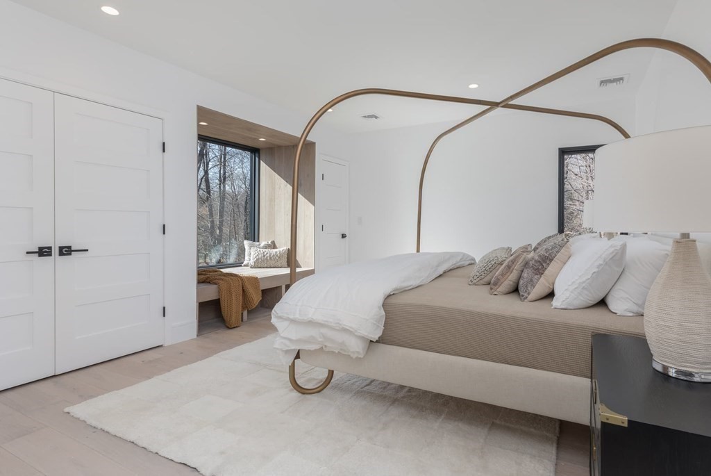 11 Willard Road Weston, MA 02493 - Photo 25 of 42 a bedroom with a bed and a mirror