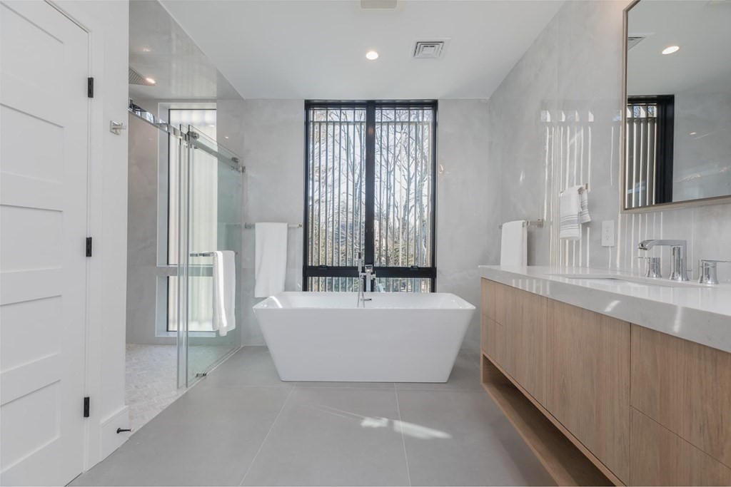 11 Willard Road Weston, MA 02493 - Photo 27 of 42 a bath room with a sink mirror and a bathtub