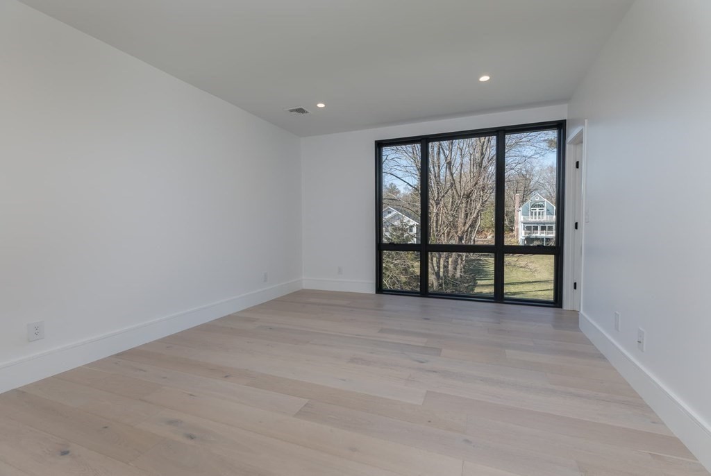 11 Willard Road Weston, MA 02493 - Photo 30 of 42 wooden floor in an empty room with a window